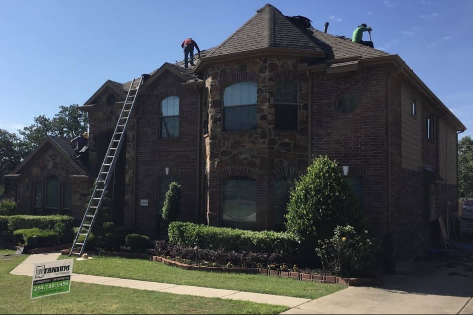 A two story home in Denton showing our workers trying to complete it in one day. Our roofing sign is in the front yard