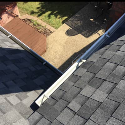 An aerial shot of a black roof with gutters in Denton TX.