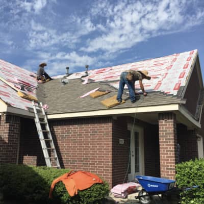 Our construction workers replacing a roof in the summer.