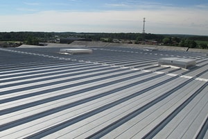 A commercial warehouse with a metal roof on it.